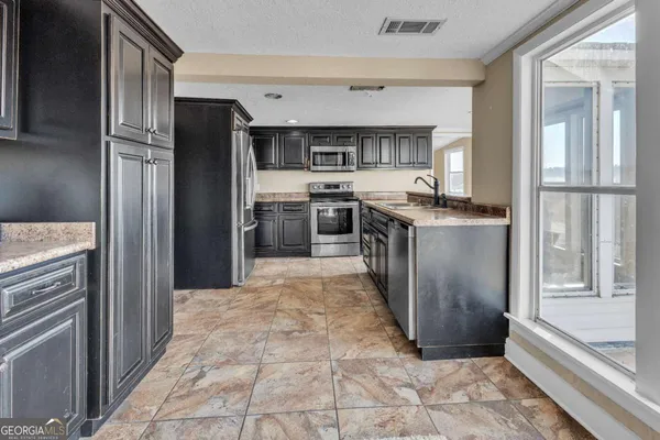 a view of a kitchen with furniture and a kitchen