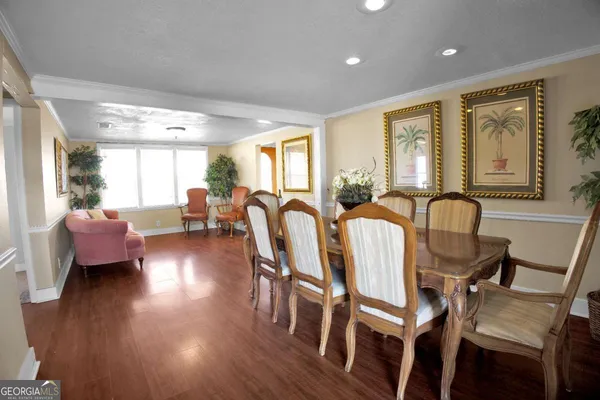a view of a dining room with furniture and wooden floor