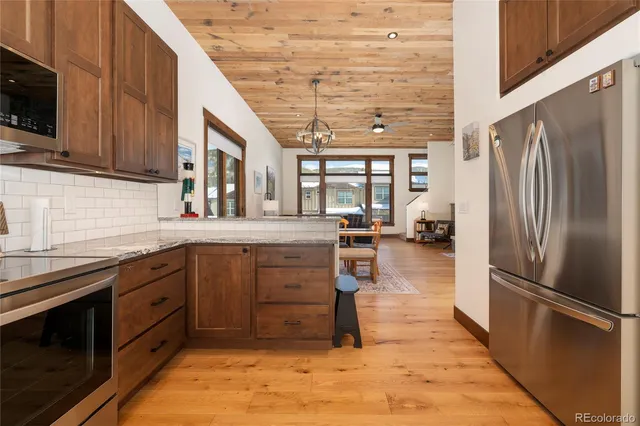 a kitchen with a sink a counter top space appliances and cabinets