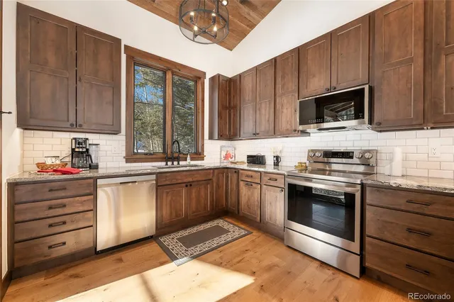 a en suite bathroom with a granite countertop sink and a mirror