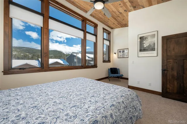 a bathroom with a granite countertop toilet a sink and mirror