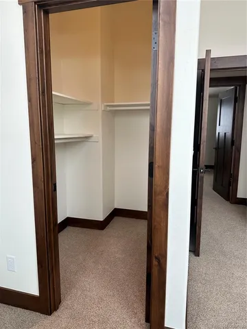 a bedroom with two beds and a desk