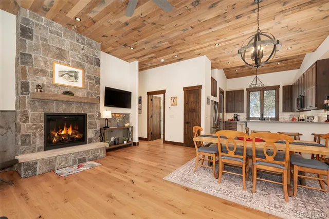 a living room with furniture fireplace and a large window