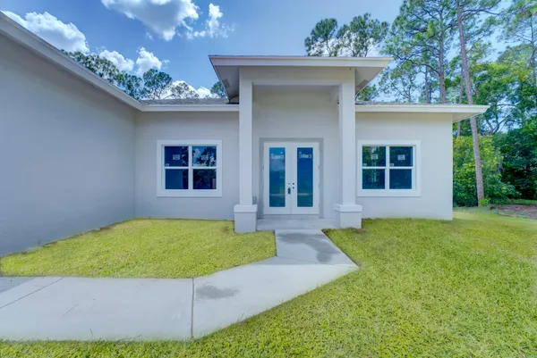 a view of a house with a porch and a yard