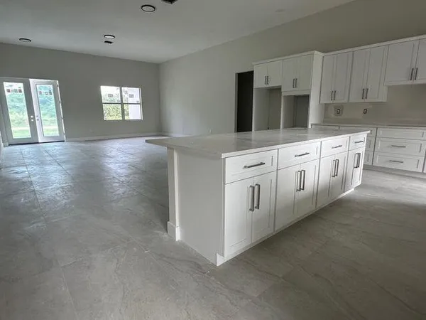 a view of kitchen with window and refrigerator