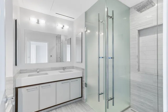 a bathroom with a granite countertop sink a toilet and shower