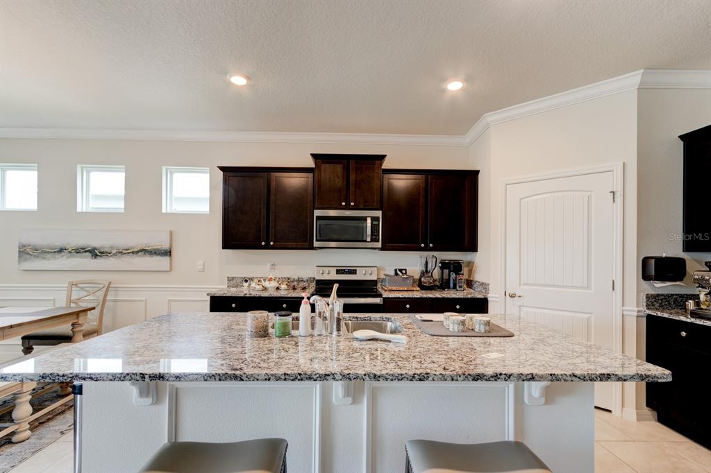 1706 Red Rock Road New Smyrna Beach, FL 32168 - Photo 14 of 27 a kitchen with stainless steel appliances granite countertop a sink and a stove