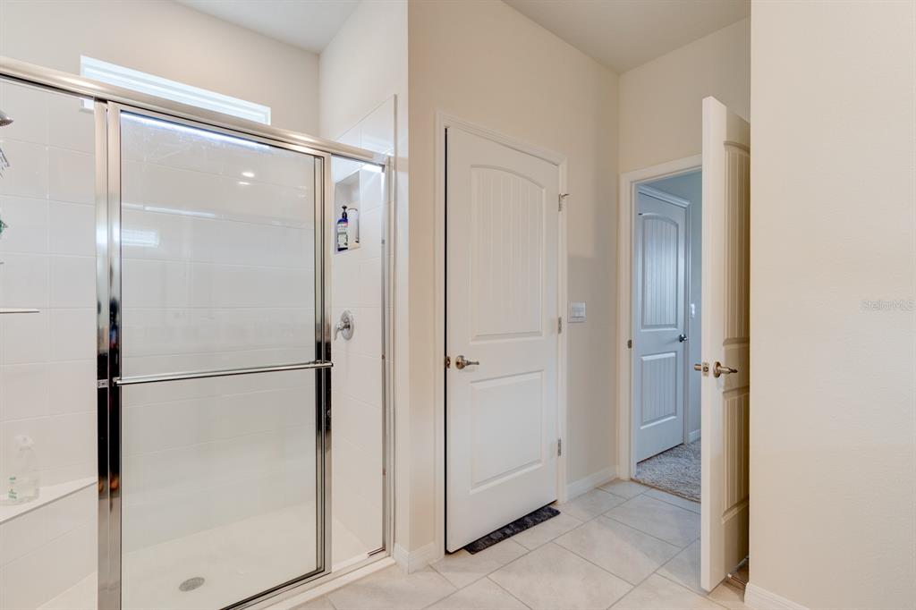 1706 Red Rock Road New Smyrna Beach, FL 32168 - Photo 23 of 27 a bathroom with a glass shower door