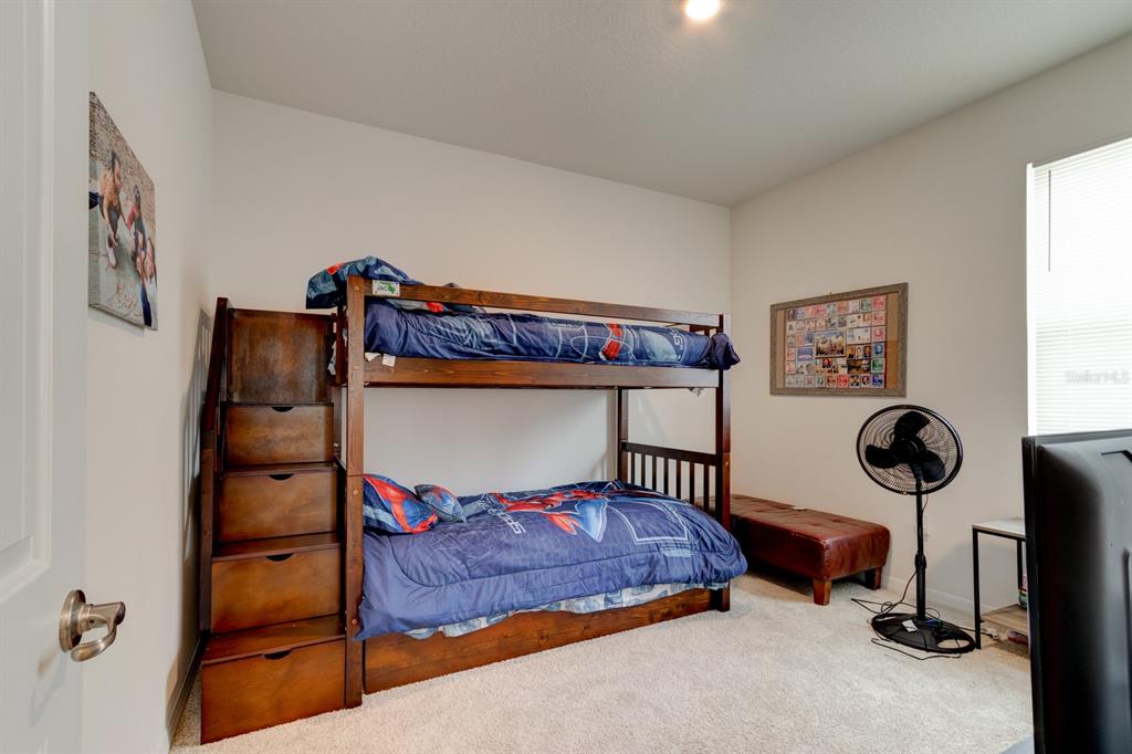 1706 Red Rock Road New Smyrna Beach, FL 32168 - Photo 6 of 27 a bedroom with a bed and cabinets