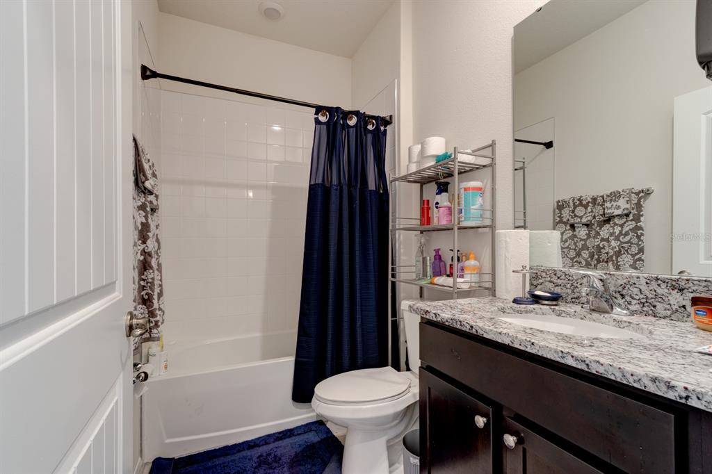 1706 Red Rock Road New Smyrna Beach, FL 32168 - Photo 7 of 27 a bathroom with a granite countertop sink toilet and shower