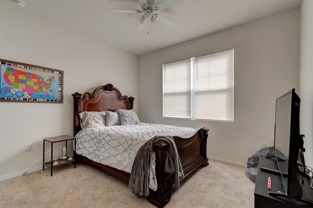 1706 Red Rock Road New Smyrna Beach, FL 32168 - Photo 8 of 27 a bedroom with a bed and a flat tv screen on the dresser