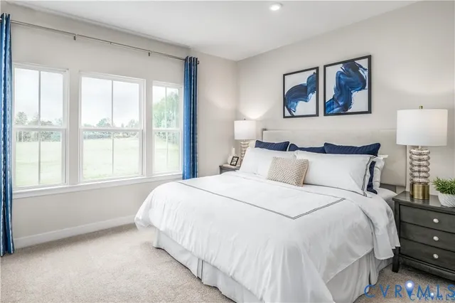 a large bed sitting in a bedroom next to a window