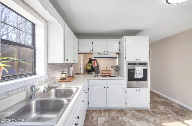 a kitchen with stainless steel appliances a refrigerator sink and cabinets