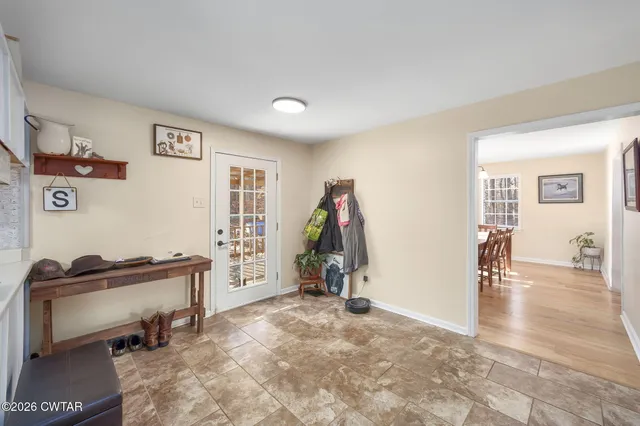 a view of a kitchen with furniture and a refrigerator
