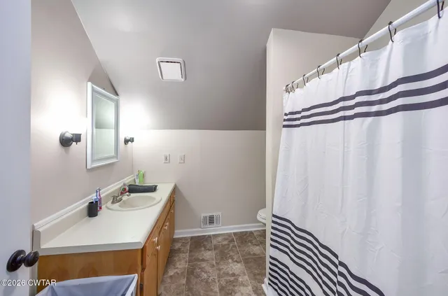 a bed room with furniture and a chandelier