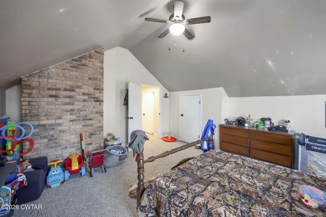 a bedroom with furniture and a window