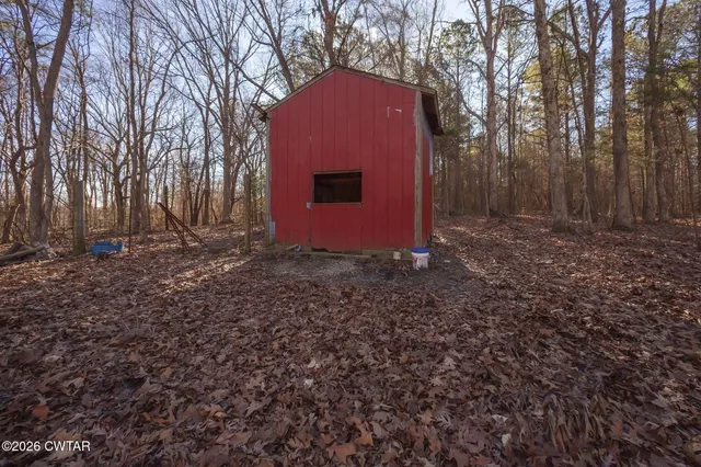 a view of backyard with large trees