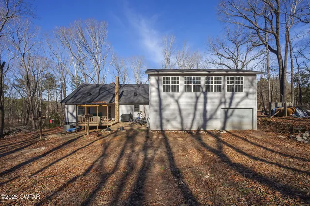 a view of a house with yard and sitting area