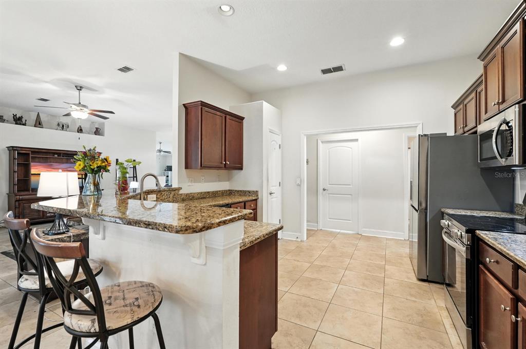 8 Zorro Court Palm Coast, FL 32164 - Photo 12 of 43 a kitchen with stainless steel appliances granite countertop a sink and a refrigerator