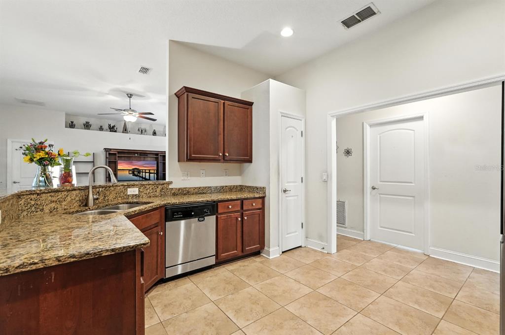 8 Zorro Court Palm Coast, FL 32164 - Photo 13 of 43 a kitchen with stainless steel appliances granite countertop a stove and a sink