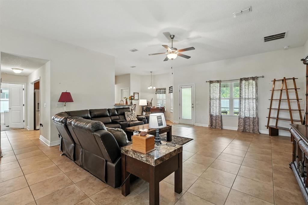 8 Zorro Court Palm Coast, FL 32164 - Photo 14 of 43 a living room with furniture a chandelier and a view of kitchen