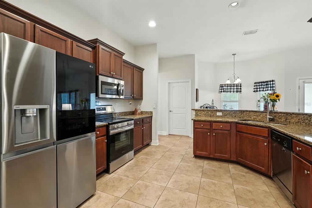 8 Zorro Court Palm Coast, FL 32164 - Photo 15 of 43 a kitchen with stainless steel appliances granite countertop a refrigerator and a sink