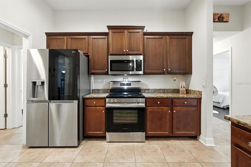 8 Zorro Court Palm Coast, FL 32164 - Photo 16 of 43 a kitchen with stainless steel appliances granite countertop a refrigerator and a stove