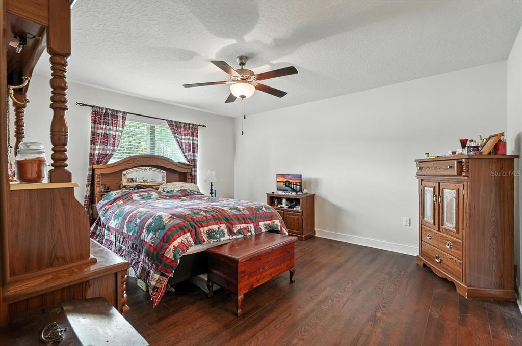 8 Zorro Court Palm Coast, FL 32164 - Photo 20 of 43 a bedroom with a bed and a chandelier