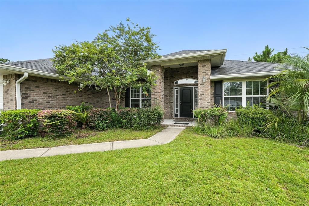 8 Zorro Court Palm Coast, FL 32164 - Photo 2 of 43 a front view of a house with a yard