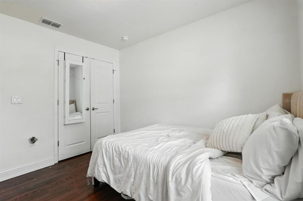 8 Zorro Court Palm Coast, FL 32164 - Photo 25 of 43 a bedroom with a bed and wooden floor