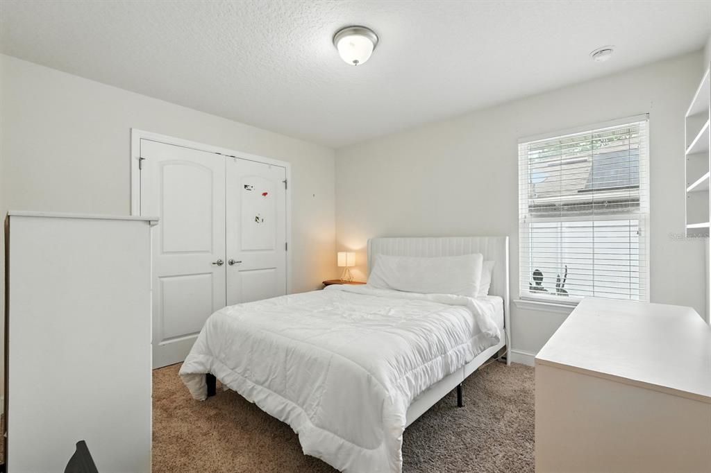 8 Zorro Court Palm Coast, FL 32164 - Photo 26 of 43 a bedroom with a bed and a night stand