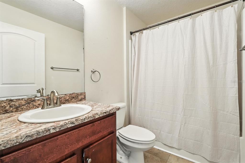 8 Zorro Court Palm Coast, FL 32164 - Photo 29 of 43 a bathroom with a granite countertop sink and a mirror