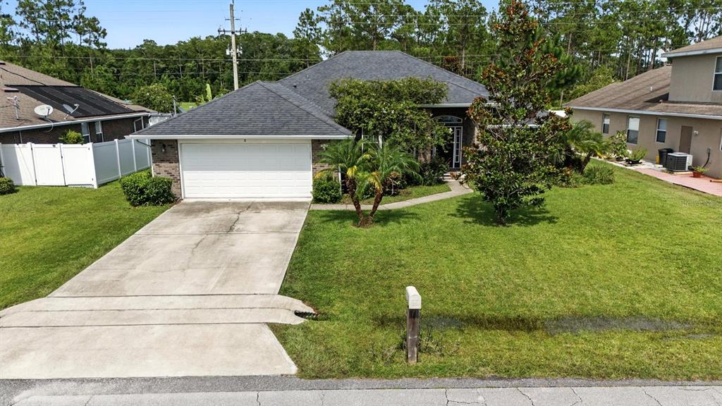 8 Zorro Court Palm Coast, FL 32164 - Photo 40 of 43 a front view of house with yard and green space