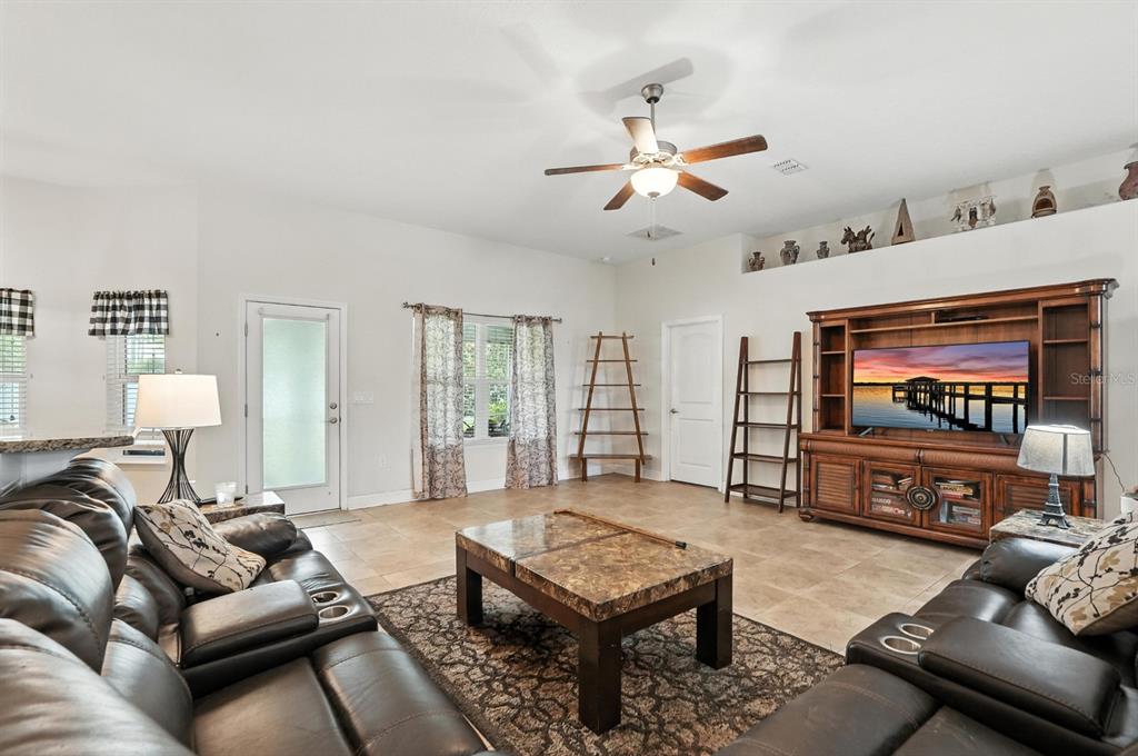 8 Zorro Court Palm Coast, FL 32164 - Photo 9 of 43 a living room with furniture and a flat screen tv