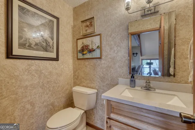 a bedroom with a large bed and a large mirror