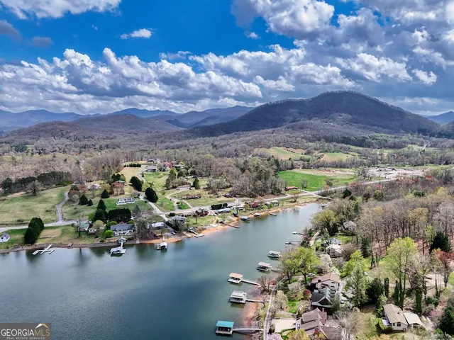 a view of house with lake swimming pool and outdoor seating