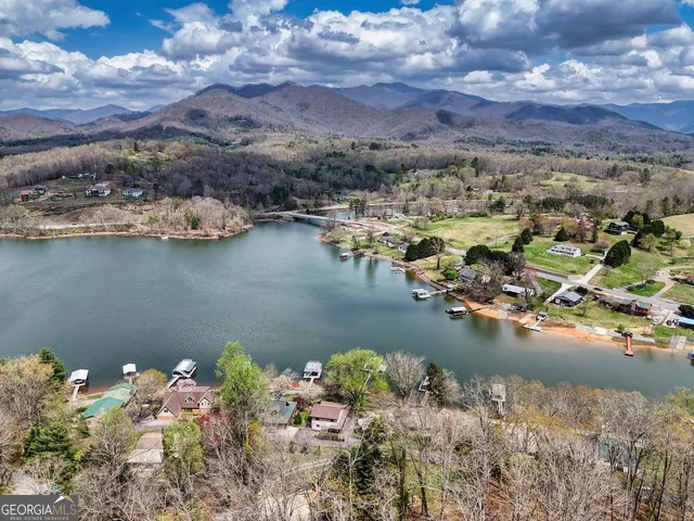 a view of a patio with table and chairs with wooden floor and fence