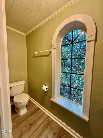 a large kitchen with kitchen island granite countertop a refrigerator and wooden floor