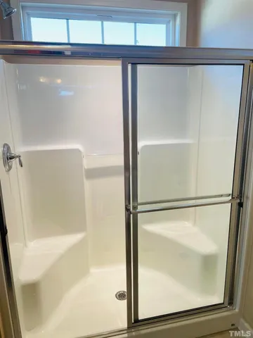 a bathroom with a glass shower door