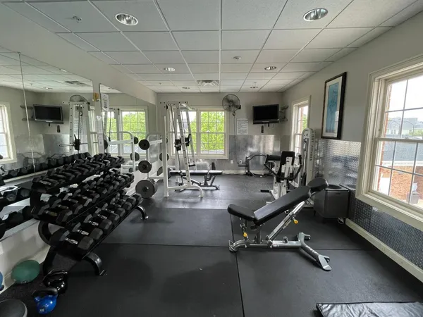 a room with gym equipment and a large window