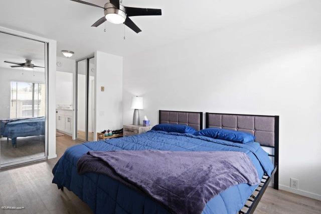 a bedroom with a large bed and a chandelier