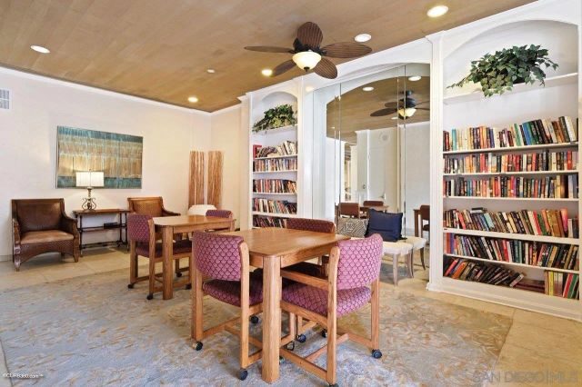 a view of a a dining room with furniture and a bookshelf