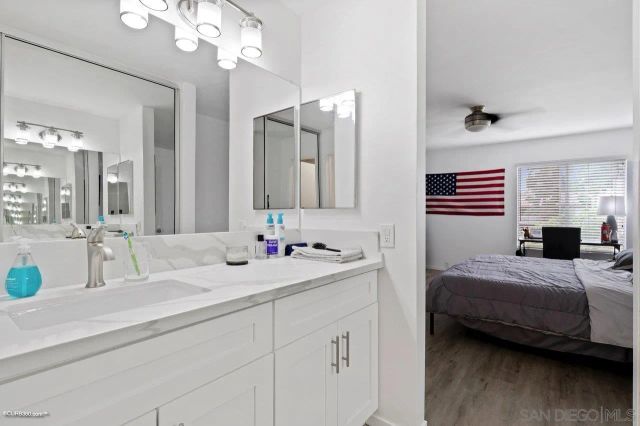 a en suite bathroom with a double vanity sink and a mirror