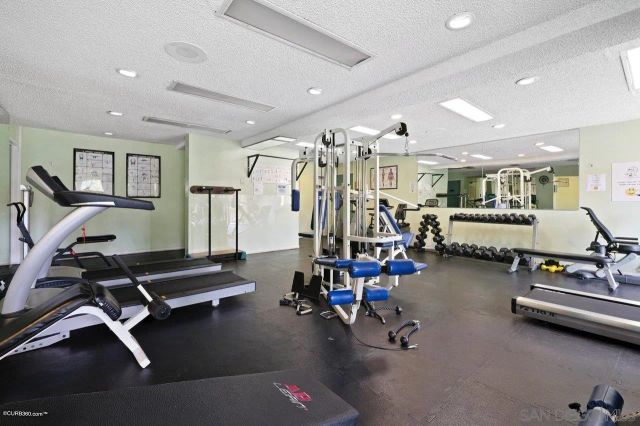 a living room with gym equipment and gym equipment