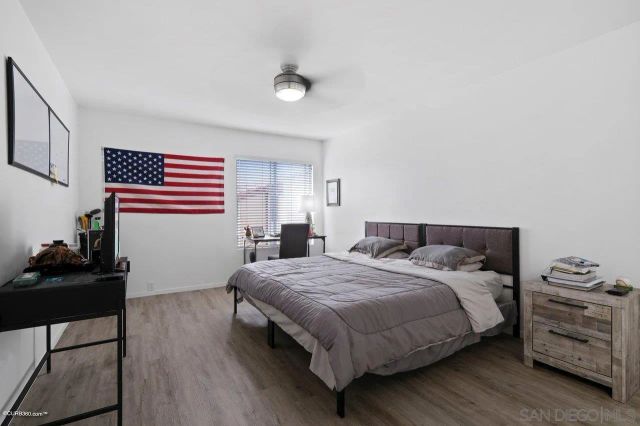 a bedroom with a bed and a dresser in it