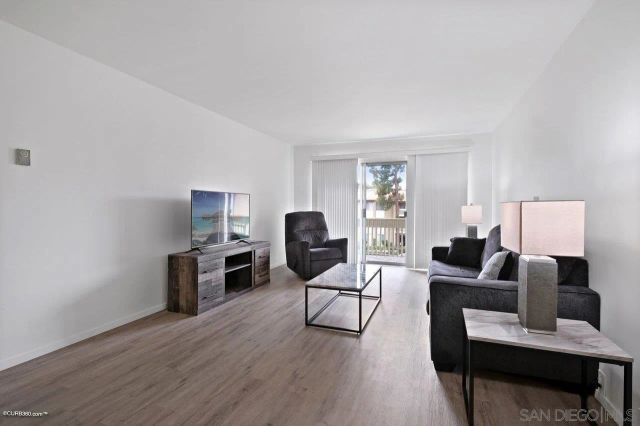 a living room with furniture or couch and a wooden floor