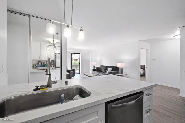 a view with a sink and a refrigerator