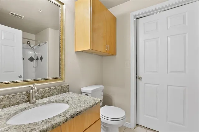 a bathroom with a granite countertop sink and a bathtub