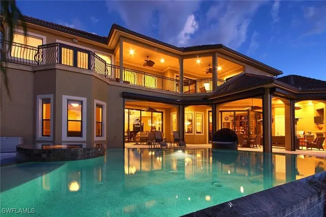 a swimming pool with outdoor seating