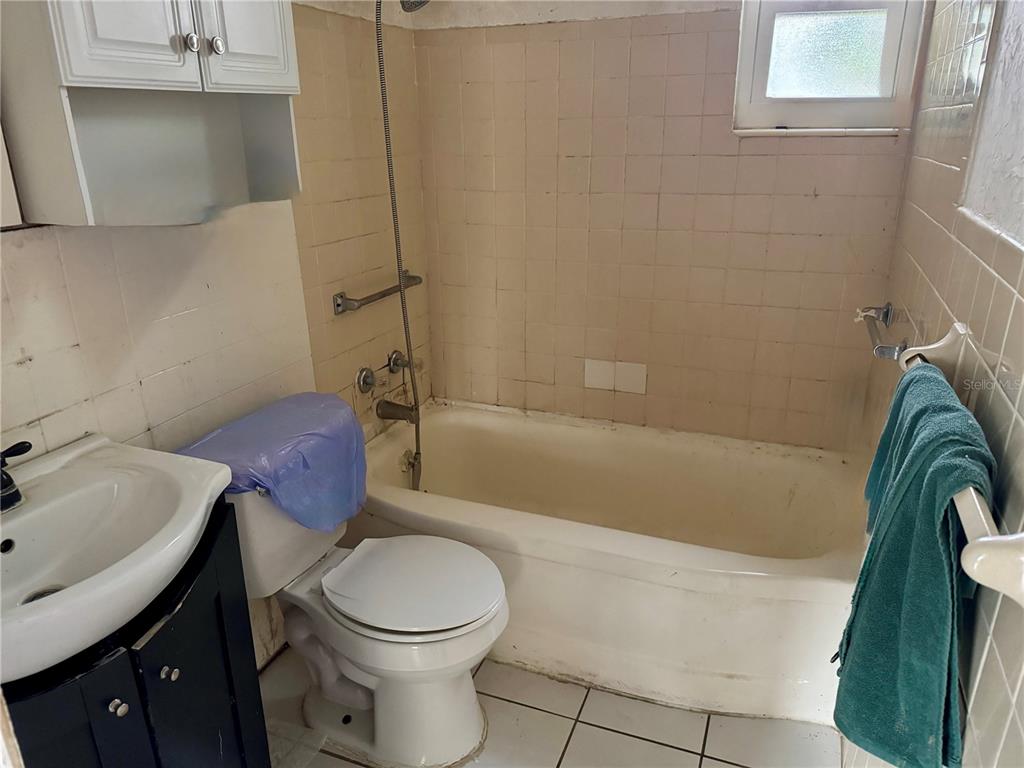 200 10th Avenue North Indian Rocks Beach, FL 33785 - Photo 10 of 15 a bathroom with a sink a toilet and bathtub